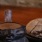 a candle next to a bowl of food