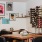 a room with a table chairs and a wall with pictures on it