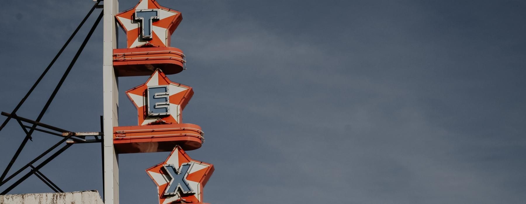 a white tower with a Texas sign